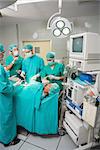 Patient lying on a medical bed undergoing an operation in an operating theatre