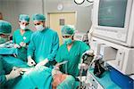 Surgical team next to a monitor in an operating theatre