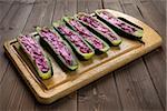 Filled zucchini with ricotta and beet on wood cutting board