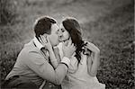 romantic couple kissing in the field, black and white