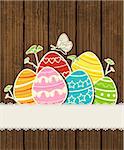 Vector wooden background with decorative Easter eggs