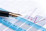 Business concept. Closeup of fountain pen near ruler on paper background with business chart