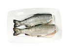two fresh trout on white plate