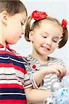 two beautiful happy children decorate christmas tree