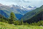 Summer mountain cloudy landscape with snow on mount top (Alps, Switzerland)