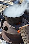 The process of boiling maple sap to create maple syrup,  using a traditional method.