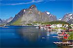 Scenic town of Reine by the fjord on Lofoten islands in Norway on sunny summer day