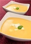 two portions of pumpkin soup
