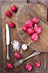 Still life with radishes and salt on a wooden background