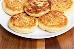 delicious traditional cheese pancakes in plate on wooden table