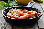 shrimp fried with herbs and spices in a pan