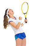 Happy female tennis player with racket rejoicing success