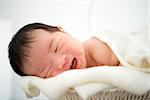 Newborn Asian baby girl smiling, 7 days after birth