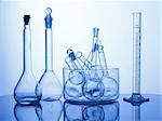 Research Lab assorted Glassware Equipment on blue background