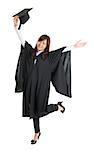 Full body excited Asian female student in graduation gown hands raised open arms jumping isolated on white background