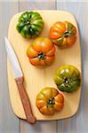 Overhead View of Tomatoes on cutting Board with Knife, Studio Shot