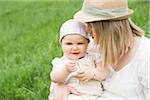 Portrait of Mother with Daughter Sitting on her Lap Outdoors, Mannheim, Baden-Wurttemberg, Germany