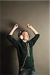 Boy Listening to Music with Headphones, Studio Shot