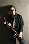 Portrait of Boy with Skateboard, Studio Shot