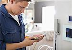 Electrician working on telephone in home