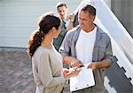 Woman signing for package in driveway