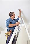 Electrician working on ceiling lights