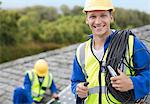 Worker smiling on rooftop