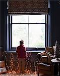 Boy playing with Christmas lights