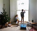 Children in living room with Christmas tree