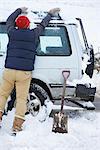 Man digging car out of snow