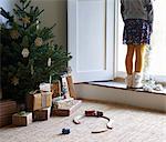 Girl with Christmas tree and gifts