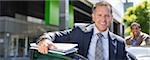 Businessman climbing out of car