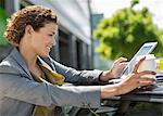 Businesswoman using tablet computer outdoors