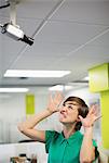 Businesswoman making face at security camera