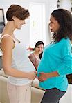 Pregnant women touching bellies