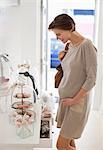 Pregnant woman admiring cookies in store