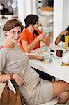 Pregnant woman having cup of coffee with friends