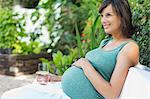 Pregnant woman relaxing outdoors