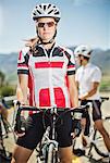 Cyclist standing by bicycle before race