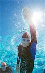 Triathlete in wetsuit underwater