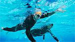 Triathletes in wetsuits underwater