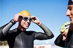 Triathlete adjusting goggles outdoors