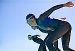 Triathletes diving into water outdoors