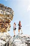 Climbers examining steep rock face