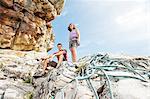 Climbers with rope on rock formation