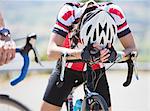 Disappointed cyclist resting on handlebars