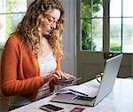 Woman paying bills on laptop