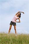 Woman Exercising In A Meadow