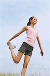 Woman Exercising In A Meadow