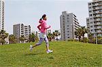 Woman Running On Grass